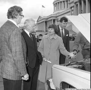 ["Senator Robert C. Byrd looks at the engine of a car at an alternative motor fuels event outside the Senate."]%