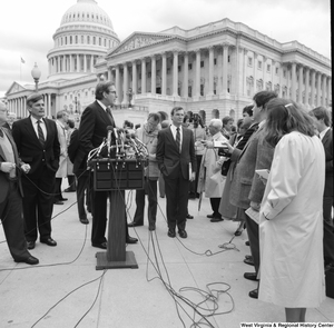 ["Senator John D. (Jay) Rockefeller answers questions at an alternative motor fuels event outside the Senate."]%