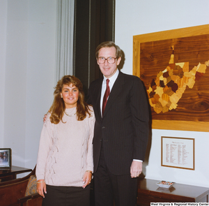 ["Senator John D. (Jay) Rockefeller stands next to an unidentified young woman in his office."]%