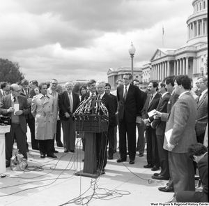 ["Senator Robert C. Byrd speaks at an event outside the Senate."]%