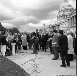 ["Senator John D. (Jay) Rockefeller stands next to Senator Robert C. Byrd and speaks at an event outside the Senate building."]%