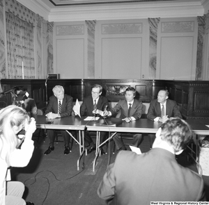 ["Senator John D. (Jay) Rockefeller and four other men sit behind a table at some sort of press event at the Senate."]%