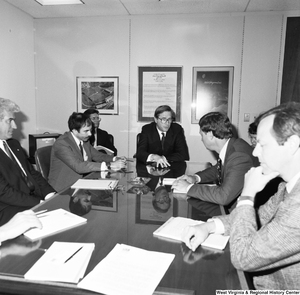 ["Senator John D. (Jay) Rockefeller and Congressman Bob Wise sit at a conference table with several unidentified individuals."]%