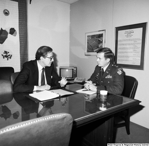 ["Senator John D. (Jay) Rockefeller sits in his office and talks with Colonel Farewell of the Huntington Corps of Engineers."]%