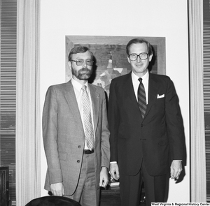 ["Senator John D. (Jay) Rockefeller stands with an unidentified man in his office."]%