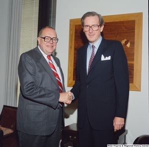 ["Senator John D. (Jay) Rockefeller shakes hands with a representative from the Veteran's Administration in his office."]%