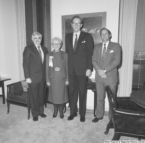 ["Senator John D. (Jay) Rockefeller stands with three unidentified guests in his office."]%