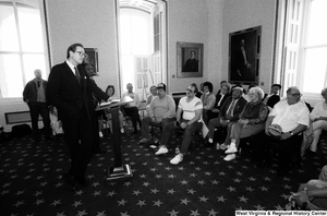 ["Senator John D. (Jay) Rockefeller stands before a group of people at a meeting about the problem of black lung disease in West Virginia."]%