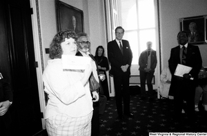 ["An unidentified woman holds up a sheet of paper before Senator John D. (Jay) Rockefeller speaks at an event about the black lung problem in West Virginia."]%