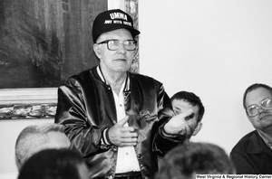 ["A man wearing a UMWA hat stands to ask Senator John D. (Jay) Rockefeller a question."]%