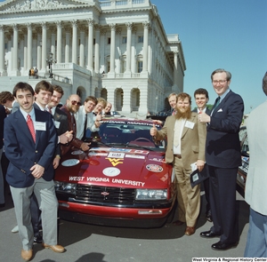 ["Senator John D. (Jay) Rockefeller stands outside the Senate with members of West Virginia University's ethanol/methanol vehicle team."]%