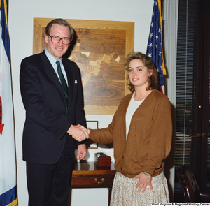 ["Senator John D. (Jay) Rockefeller shakes hands with a young woman in his office."]%