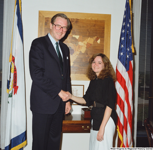 ["Senator John D. (Jay) Rockefeller shakes hands with a young woman."]%