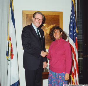 ["Senator John D. (Jay) Rockefeller shakes hands with a young woman."]%