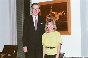 ["Senator John D. (Jay) Rockefeller stands next to one of his interns."]%