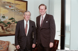 ["Senator John D. (Jay) Rockefeller stands next to an unidentified man in his office."]%