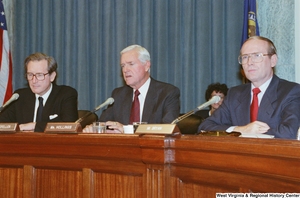 ["Senator John D. (Jay) Rockefeller sits beside Senators Hollings and Bryan during a Commerce Committee hearing."]%