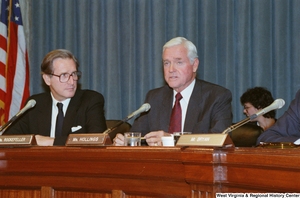 ["Senator John D. (Jay) Rockefeller looks at Senator Ernest Hollings while he speaks at a Commerce Committee hearing."]%