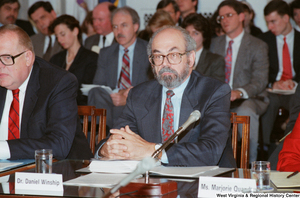 ["Dr. Daniel Winship sits at a Senate conference event."]%