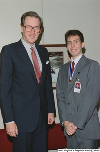 ["Senator John D. (Jay) Rockefeller stands with a West Virginia participant in the United States Senate Youth Program."]%