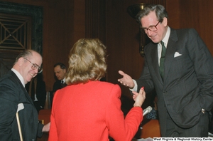 ["Senator John D. (Jay) Rockefeller speaks with a woman after a Senate sub-committee hearing."]%