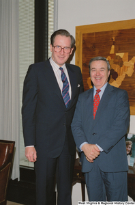 ["Senator John D. (Jay) Rockefeller stands with a representative of the Brotherhood of Locomotive Engineers in his office."]%