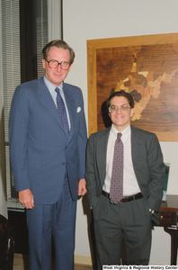 ["Senator John D. (Jay) Rockefeller stands beside an unidentified man in his office."]%