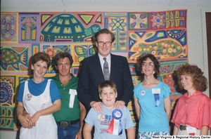 ["Senator John D. (Jay) Rockefeller stands with a group of unidentified individuals."]%