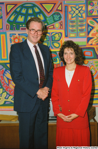 ["Senator John D. (Jay) Rockefeller stands next to an unidentified woman in his office."]%