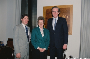 ["Senator John D. (Jay) Rockefeller stands next to two unidentified individuals from Riverside Apostolic Church in his office."]%