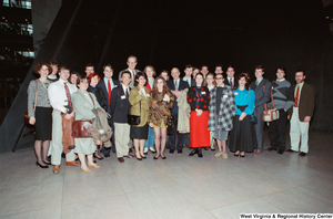 ["Senator John D. (Jay) Rockefeller stands with a group of students in the atrium of the Hart Office Building."]%