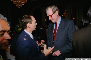 ["Senator John D. (Jay) Rockefeller speaks with a military member at a Celebrating Telemedicine conference."]%