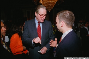 ["Senator John D. (Jay) Rockefeller speaks with an unidentified man at the Celebrating Telemedicine conference."]%