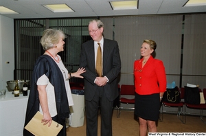 ["Senator John D. (Jay) Rockefeller speaks with an unidentified individual at a recognition ceremony hosted by the Federation of American Women's Clubs Overseas."]%