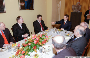 ["Senator John D. (Jay) Rockefeller sits with a group of unidentified men at an event at the Senate."]%