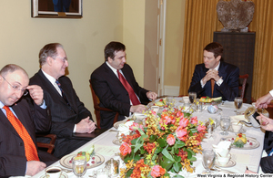 ["Senator John D. (Jay) Rockefeller sits at a table with unidentified men at an event in the Senate."]%