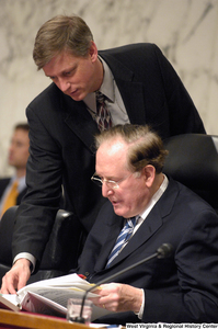 ["Senator John D. (Jay) Rockefeller reviews a document during a Senate committee hearing on intelligence."]%