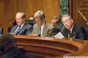 ["Three Senators; John D. (Jay) Rockefeller, Max Baucus, and Charles Grassley, read documents during a committee hearing."]%