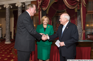 ["Senator John D. (Jay) Rockefeller shakes hands with vice president Dick Cheney after being sworn in to his last Senate term."]%