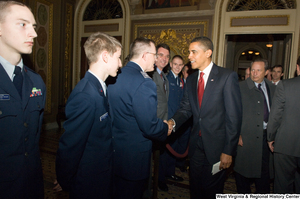 ["President Barack Obama shakes hands with a member of the Air Force during a visit to the U.S. Capitol Building."]%