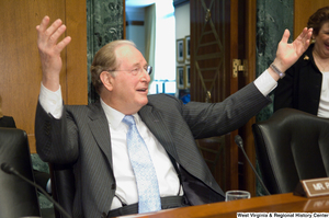 ["Senator John D. (Jay) Rockefeller holds up his arms during a Senate Finance Committee hearing."]%