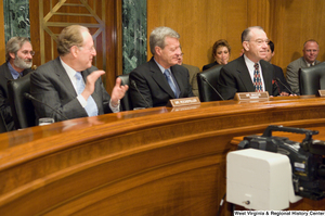 ["Senator Max Baucus takes his seat as Chairman of the Senate Finance Committee."]%