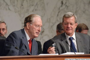 ["Senator Max Baucus shows his cellphone to Senator John D. (Jay) Rockefeller during an executive meeting on new health care reform legislation."]%