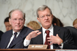 ["Senator Max Baucus speaks during a Finance Committee hearing."]%