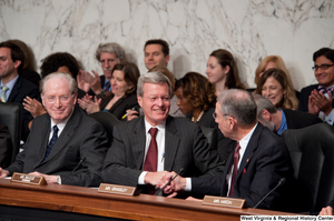 ["Senators Max Baucus and Charles Grassley shake hands during a Finance Committee hearing about health care reform legislation."]%