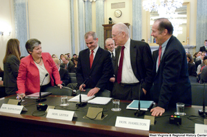 ["Secretary of Homeland Security Janet Napolitano speaks with three other men before a Senate Commerce Committee hearing."]%