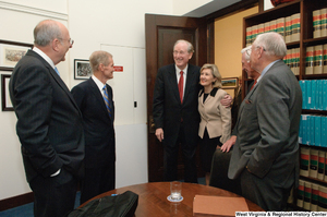 ["Senator John D. (Jay) Rockefeller and Kay Hutchison stand with other Senators outside the Commerce Committee hearing room."]%