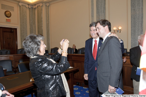 ["Senator Joe Manchin stands with an unidentified man in a room in the Senate."]%