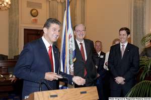 ["Senator Joe Manchin takes the podium at his swearing-in ceremony"]%