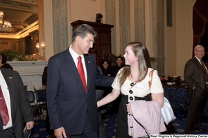 ["Senator Joe Manchin speaks with an unidentified woman after his Swearing-In Ceremony."]%